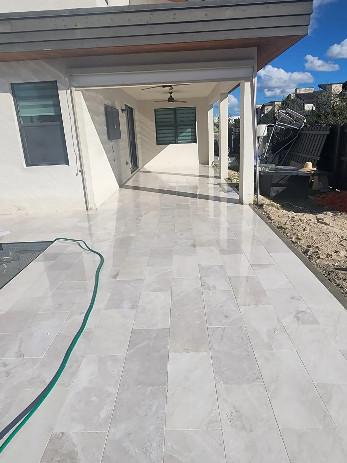 Covered patio finished in light tile