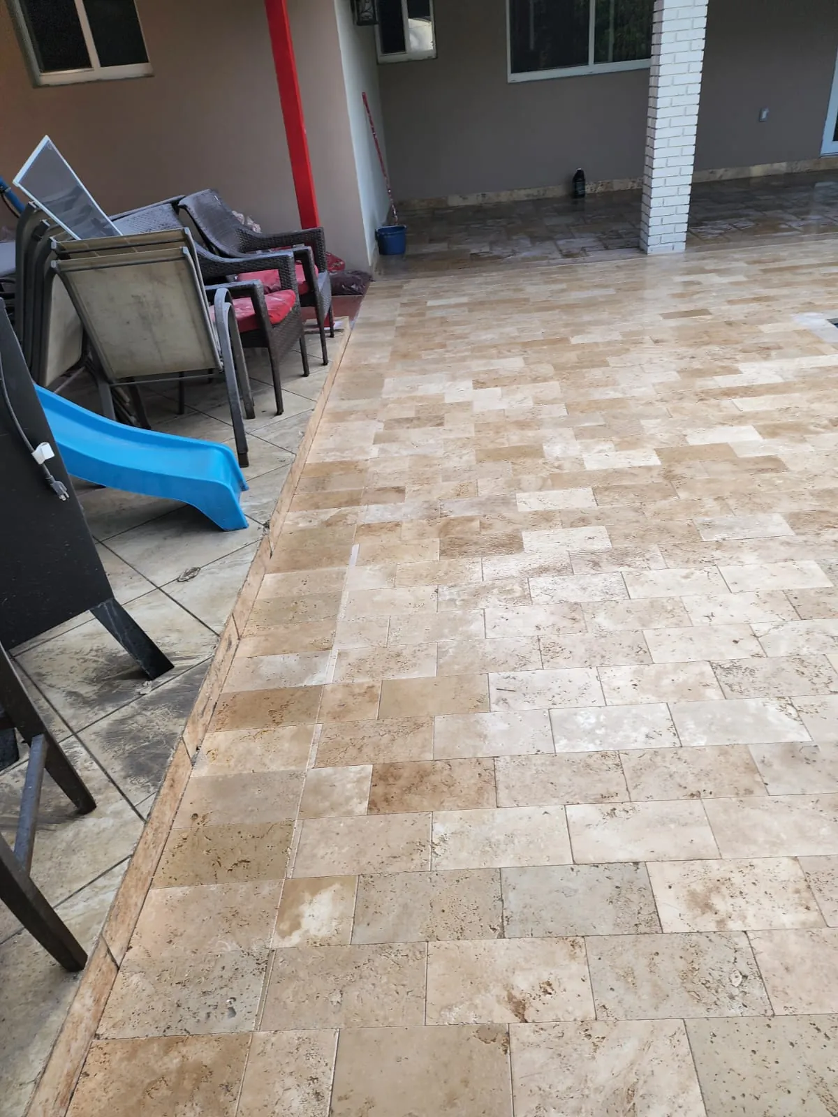 Warm stone patio beside outdoor chairs