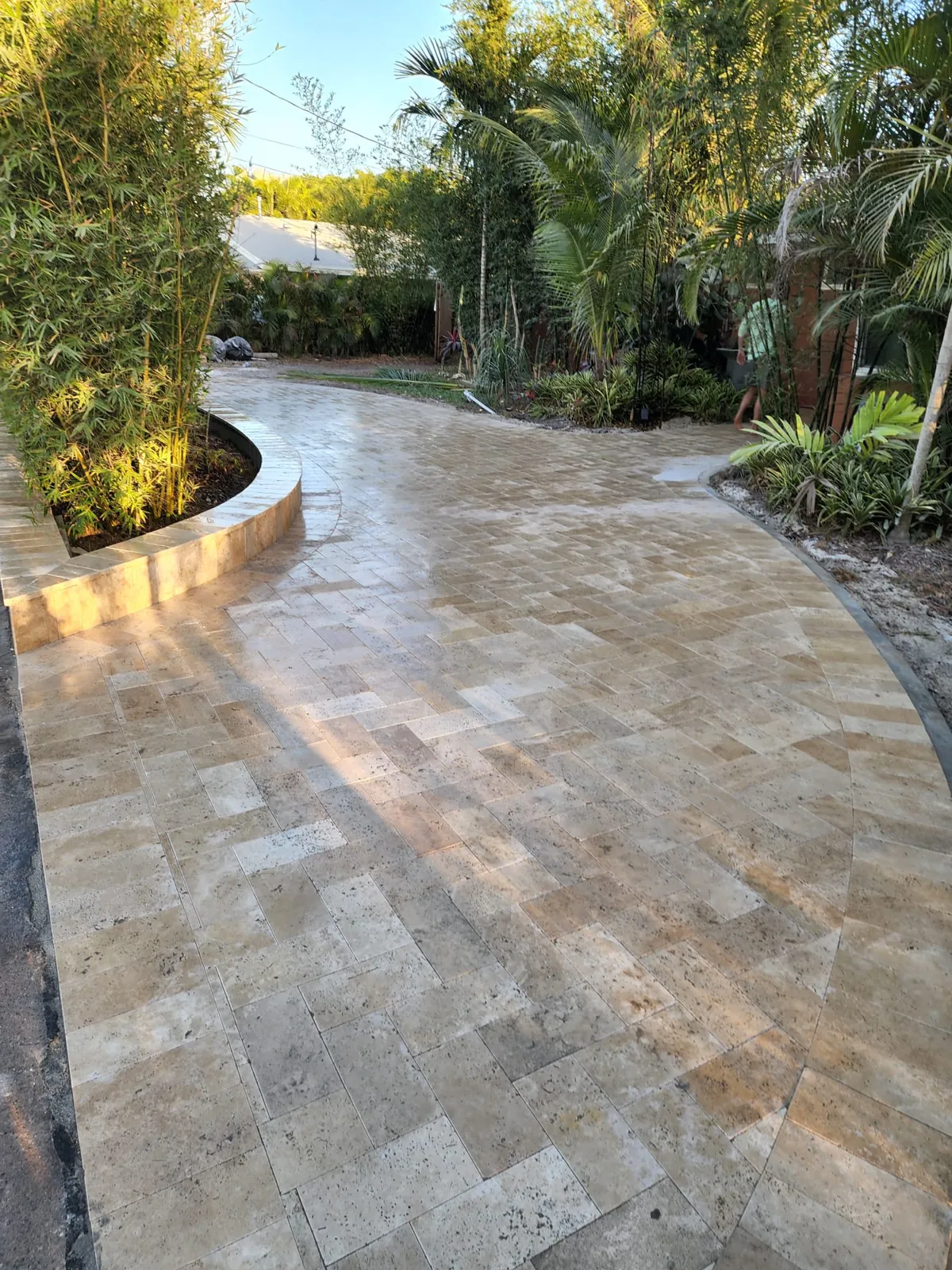 Curved stone path with a planter edge in evening light